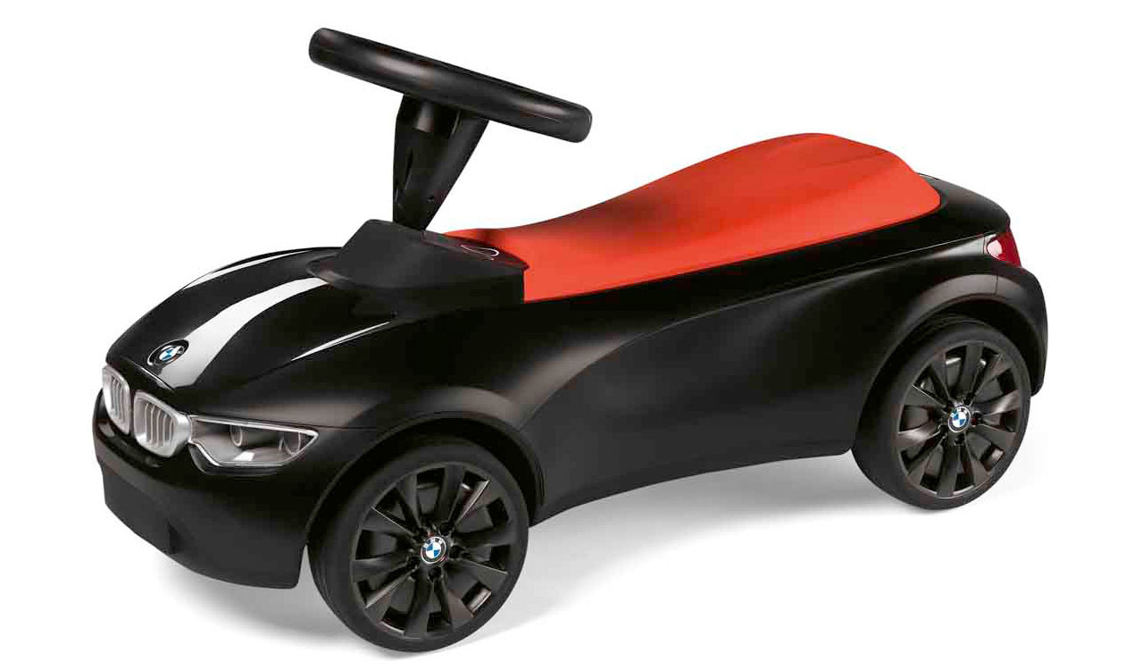 BMW Baby Racer in schwarz-orange mit Gummireifen.